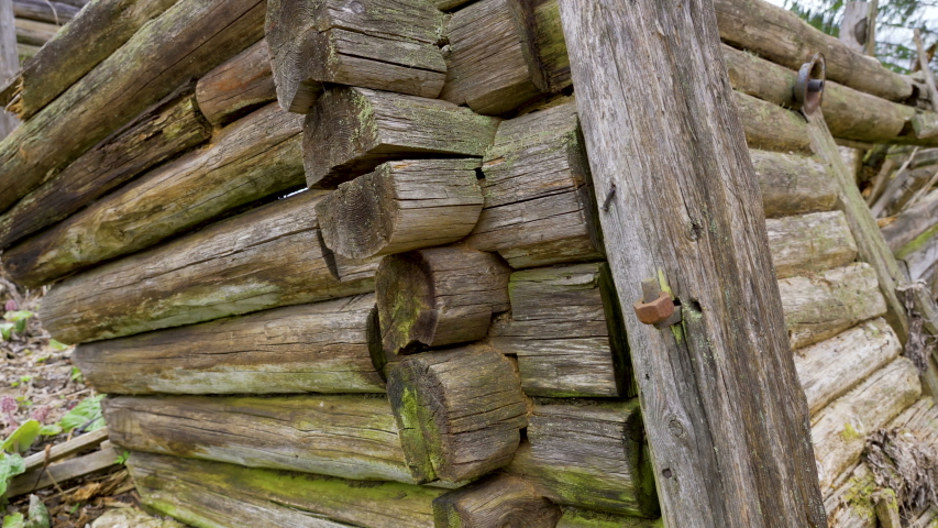 The closer look of the broken loghouse in the forest
