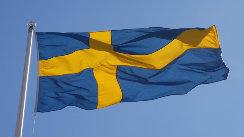 Swedish flag against blue sky | Shutterstock HD Video #1054283102