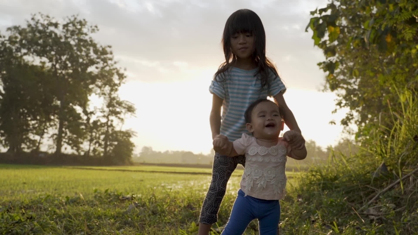 Sister to walk. ребенок сидит на бревне. Sister helping walk. Sister to walk. Sister to walk.