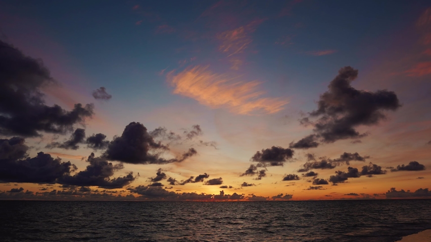 Time lapse sunrise beach Australia. Clouds fast in the sky. Time-lapse of fast flying clouds in the sky. The big sun rises from behind the clouds. Royalty-Free Stock Footage #1054284731