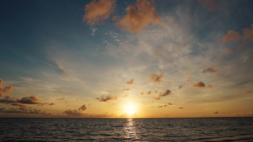 Time lapse sunrise beach Australia. Clouds fast in the sky. Time-lapse of fast flying clouds in the sky. The big sun rises from behind the clouds. | Shutterstock HD Video #1054284731