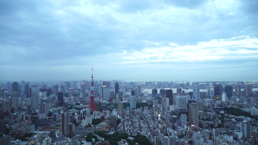 Tokyo, Japan 4K timelapse, fast motion of Tokyo city, Roppongi Hill,  Observatory deck in fast motion, timelapse from early evening to night and Tokyo Tower light up, illumination time. Royalty-Free Stock Footage #1054287929