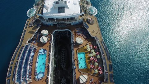 Close up aerial footage of a cruise ship sailing on the Caribbean sea. 