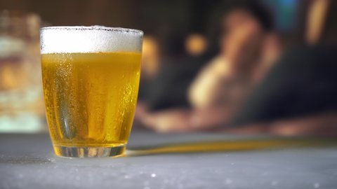 a glass of beer on bar background