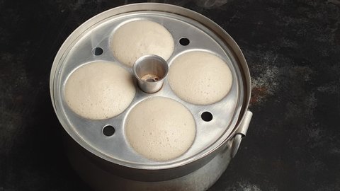 Idli or idly steamed cooking with coconut chutney powder popular breakfast of South India and Sri Lanka. Healthy steamed rice cakes are made by steaming batter consisting of fermented rice Kerala