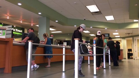 Coquitlam, BC, Canada - June 30, 2017 : Motion of people line up for waiting service inside TD Bank with 4k resolution
