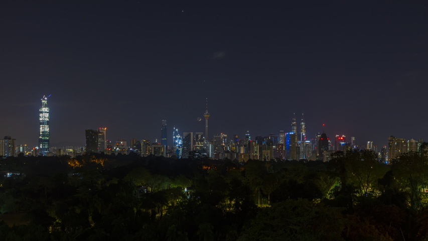 Kuala Lumpur Time lapse: Moonrise over a city view during early morning overlooking Kuala Lumpur skyline from afar with crescent moon setting. Malaysia. Prores Full HD