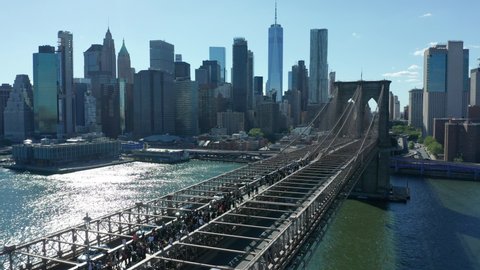 alt flying backward view of BLM marchers streaming across Brooklyn Bridge towards NYC