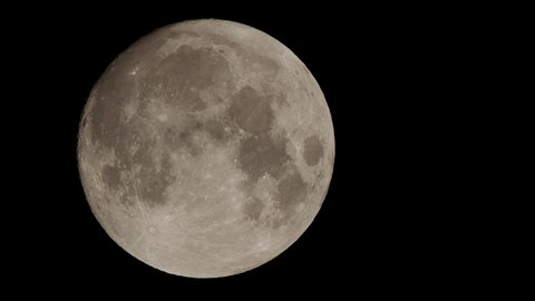 Closeup shot of the full moon, filmed with a super tele lens in UHD