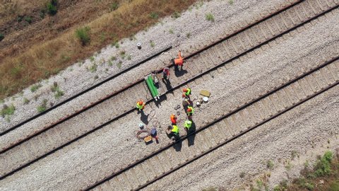 Railroad workers repairing a broken track, Top down aerial view.