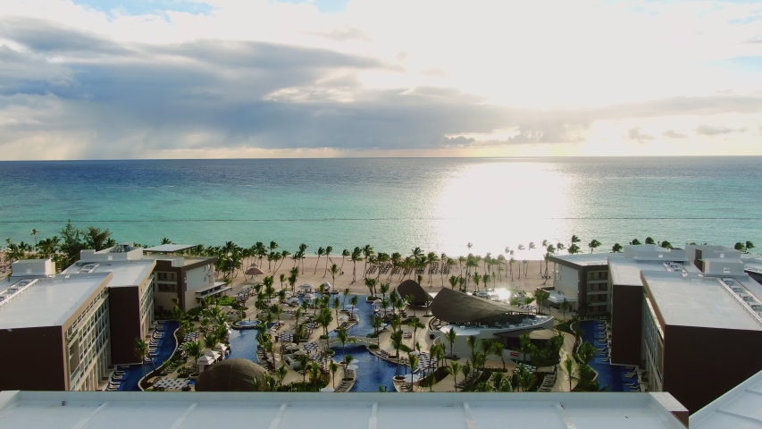 AERIAL Sun Gleaming On Ocean Waters At Tropical Beachfront Resort