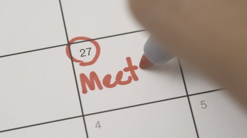 Writing meeting on a calendar agenda date