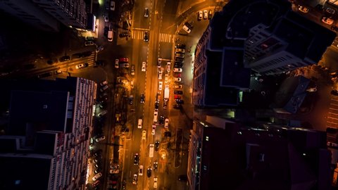 Aerial drone vertical view of Bucharest city centre square traffic hour at night
