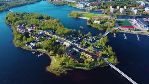4K Drone Video Dolly Shot Over a Small Island Filled with Trees and Houses In Oulu Finland