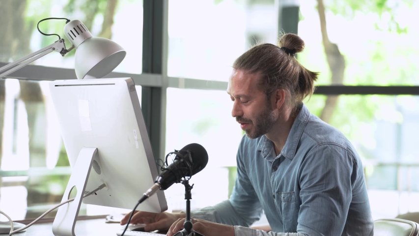 business man typing on keyboard and looking to laptop. Relaxing Male professional using computer at desk office with summer daylight from exterior. Concept working smart life with technology.