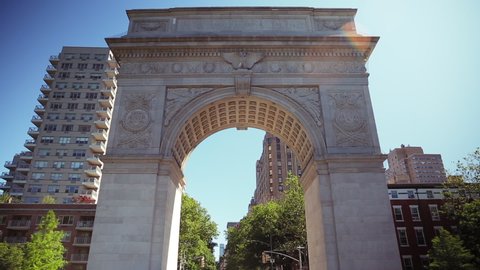a walk through the washington square park arch on a bright sunny day