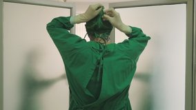 Male doctor walk into Hospital Operating Room. Diverse Team, Multi ethnic of professional surgeons and nurses suture wound having discussion for successful surgery operation on intensive care patient. - Powered by Shutterstock - Get 15% off with code: PIKWIZARD15