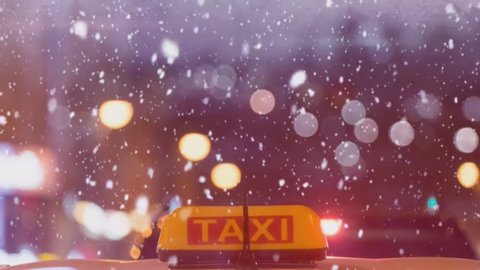Cinemagraph of a night landscape with a taxi roof under snow
