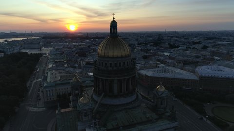 Dawn sun desert dramatic cityscape Saint Petersburg Russia St. Isaac's Cathedral golden dome cross. Historical streets old downtown. Beautiful sky clouds. Palace square, river. Horizon. Aerial forward