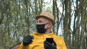 old man in mask and gloves takes glasses from girl and swipes black smartphone against village garden trees slow motion closeup - Powered by Shutterstock - Get 15% off with code: PIKWIZARD15