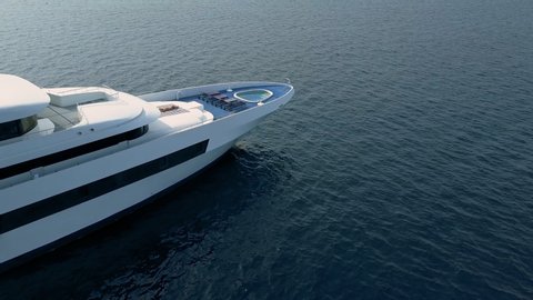 Drone flies over luxurious big white yacht with private swimming pool on deck. Young woman, star or celebrity lies down sunbathing in middle of ocean. Concept social media influencer lifestyle