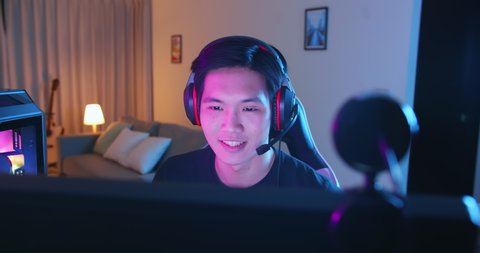 Young Asian Pro Gamer have live stream and say hi to fans happily at home