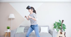 asian woman wears vr glasses and win the motion sensing game for boxing at home