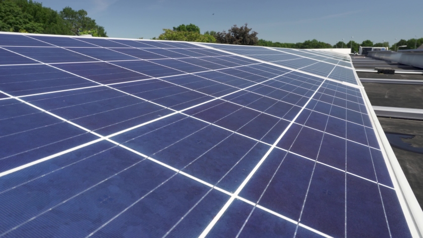 Rows of solar panels in a solar farm field on sunny day, closeup detail