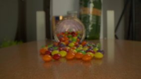Pan over round candy sweets on a wooden table. View goes right into the glass jar.  - Powered by Shutterstock - Get 15% off with code: PIKWIZARD15