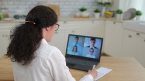 Online distance learning video conference webinar call remote work  webcam meeting concept. Back view woman talk colleagues team business partner coach at laptop home. Coronavirus COVID-19. 4 K - Powered by Shutterstock - Get 15% off with code: PIKWIZARD15