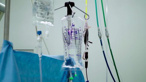 Hanging drips with blood and medication in the operating room