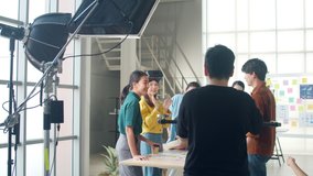 Behind the scenes of video production crew team shooting group of Asia young creative people discussing business brainstorming meeting ideas mobile application software design project in office. - Powered by Shutterstock - Get 15% off with code: PIKWIZARD15