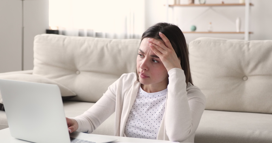 Unhappy frustrated young female student stack with hard tasks, doing homework or preparing for exams on computer. Stressed businesswoman or freelancer solving difficult problem, feeling tired. | Shutterstock HD Video #1054363256