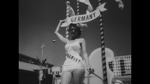CIRCA 1957 - Miss Sweden, Italy,  Austria,  Germany, and Canada wave from their individual parade floats in Long Beach, California.
