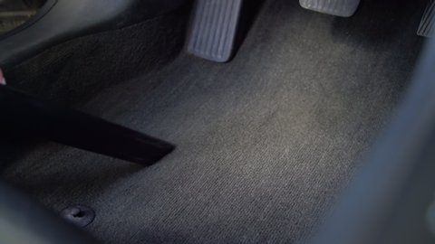 Hoovering car interior at car wash. Cleaning service. Close up vacuum cleaning textile inside the vehicle