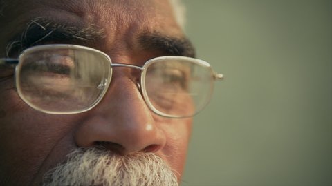 Real old black people, face expression and emotions, portrait of authentic sad elderly african american man with glasses looking away