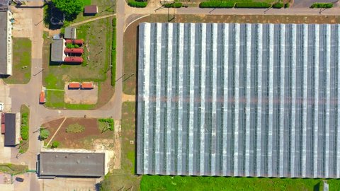 Flying over large greenhouse agriculture for growing vegetable plants, aerial drone view