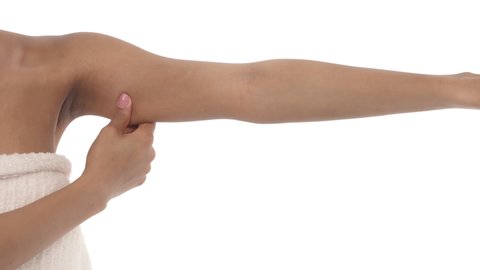 Close-up of a woman showing flabby arm, effect of aging caused by loss of elasticity and muscle. Isolated on white background