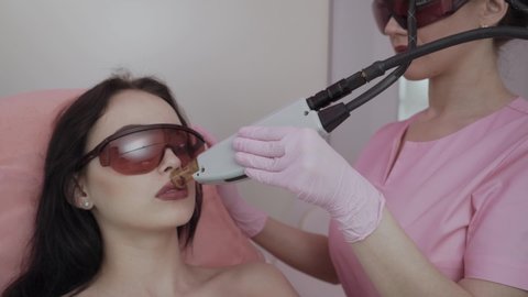 hair removal over the lip, female face during a laser hair removal procedure. female mustache removal