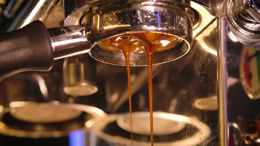 Close up slowmaton of Pouring coffee stream from professional machine , Crema Espresso Perfect Shot from coffee maker machine Royalty-Free Stock Footage #1054369523