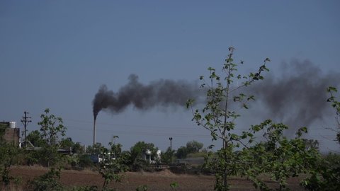 Industrial factory pollutes, smoke stacks exhaust pipes