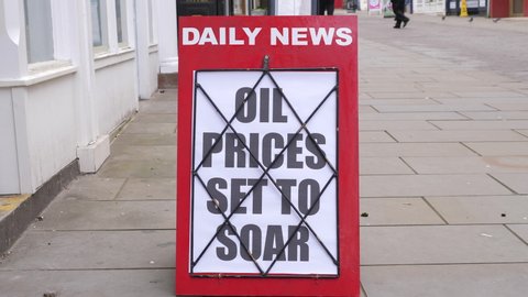 4K: Newspaper Headline Board about Oil Prices soaring and going up - News stand. Stock Video Clip Footage