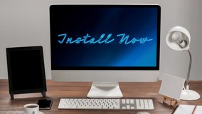 Animation of words Install Now flickering on screen of a desktop computer standing on a wooden desk. Communication and connection concept digitally generated image. - Powered by Shutterstock - Get 15% off with code: PIKWIZARD15