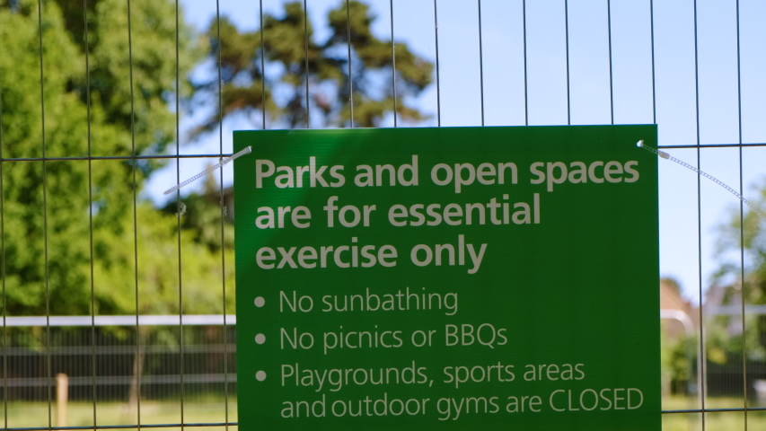 THE NEW NORMAL - Social Distancing measures are implemented at a recreational park in London, England, UK Royalty-Free Stock Footage #1054387196