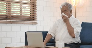 Asian senior elderly man sick at home using laptop computer to talk to doctor via video conference medical app about his medication. Doctor online technology telemedicine, telehealth concept.