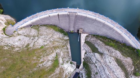Aerial drone footage top view Water dam and reservoir lake, generating hydro electricity power renewable energy and sustainable development. . High quality 4k footage