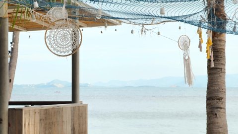 Dreamcatcher in wind at sand beach bar by the tropical island