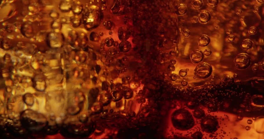 Macro of Cola Bubbles and Ice Cubes in a Glass  Royalty-Free Stock Footage #1054399622