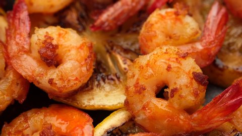 fried shrimps with lemon top view rotating. closeup