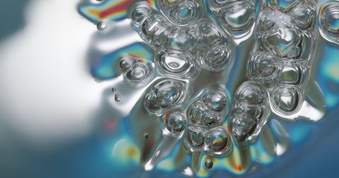 Melting Plastic Bubbles. Iridescent plastic surface melting, warping, and boiling.